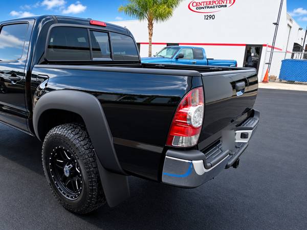 Black Toyota Tacoma, rear quarter view