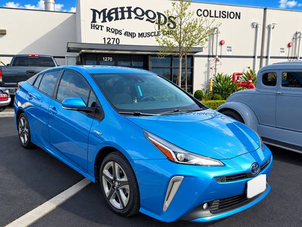 Blue Toyota Prius outside the shop