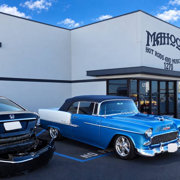 Blue and white classic Chevy parked outside the shop
