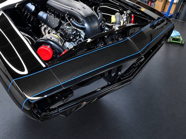 Engine bay of a custom build with blue pinstriping