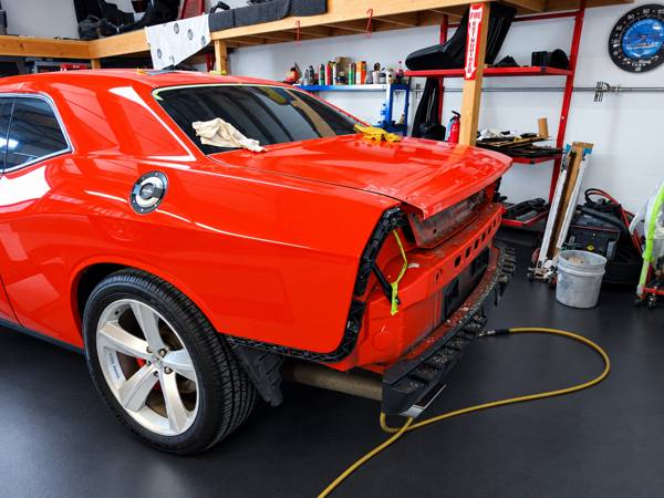 Orange Dodge Challenger with rear body work under way