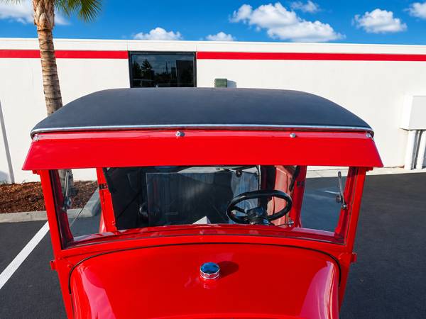 Rear view of a red hot rod body with a black top