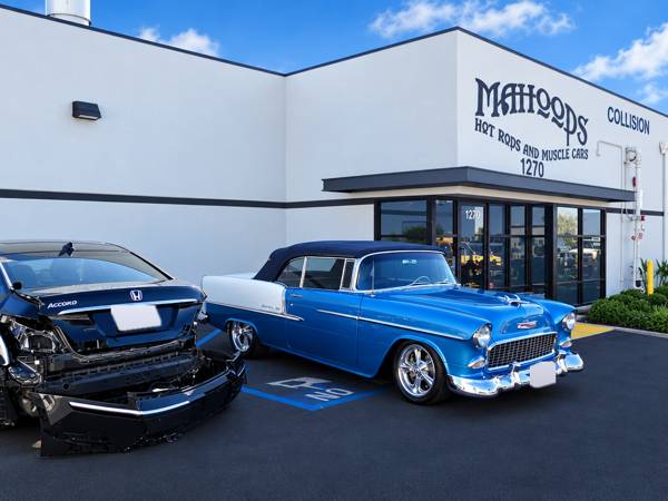 Damaged sedan and a blue and white classic Chevy parked outside Mahood's at 1270 N. Lance Ln.