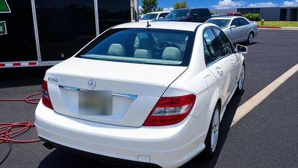 White Mercedes sedan, rear view