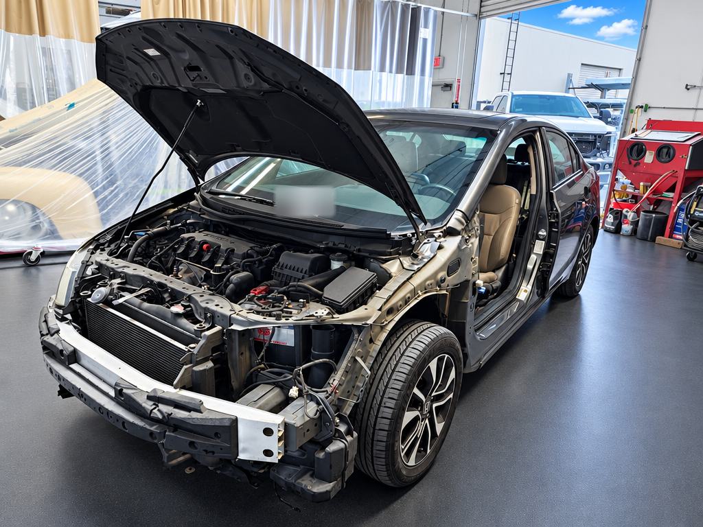 Gray Honda Civic with the front end removed for collision repair